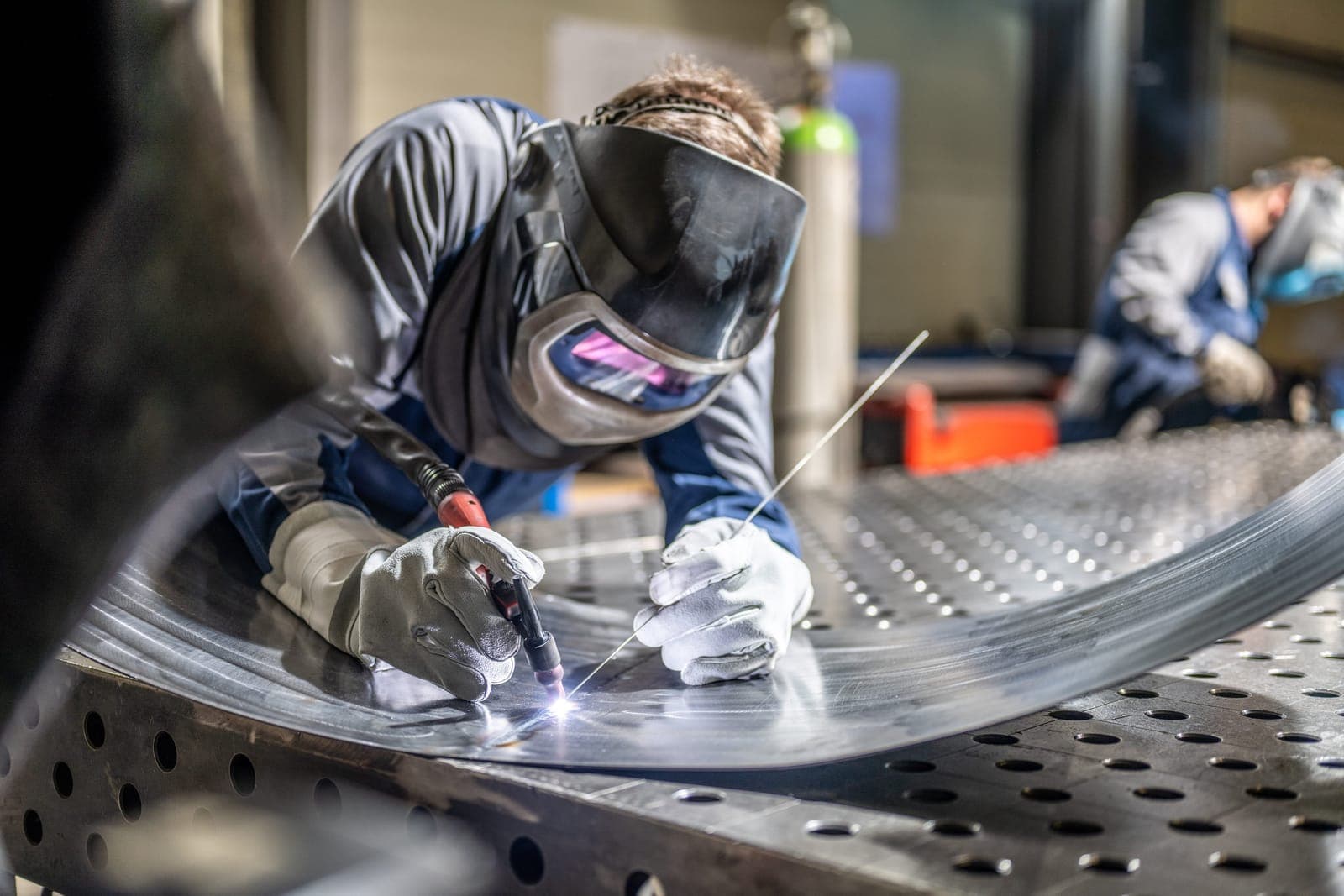 Welder at work on a metal part