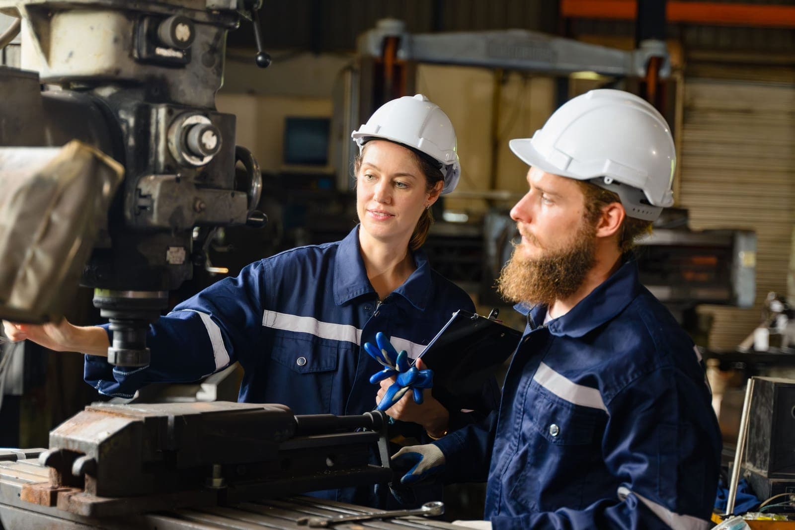 Two industrial technicians trained on a machine tool
